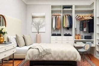 Μια όμορφα διαμορφωμένη κρεβατοκάμαρα με διακοσμητικά μαξιλάρια, τουαλέτα, φρέσκα λουλούδια και κομψά αξεσουάρ.