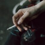 A person holding a cigarette in their hand