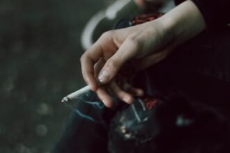 A person holding a cigarette in their hand