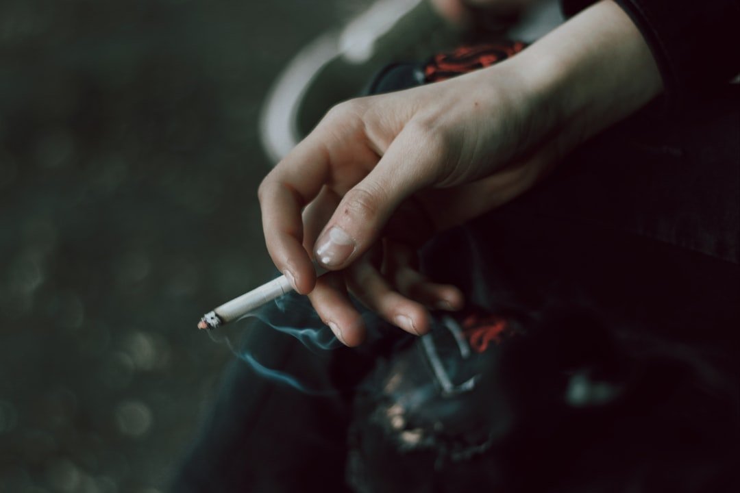 A person holding a cigarette in their hand