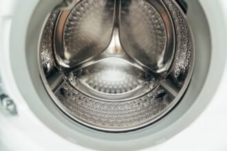 Inside view of a clean, empty washing machine drum.