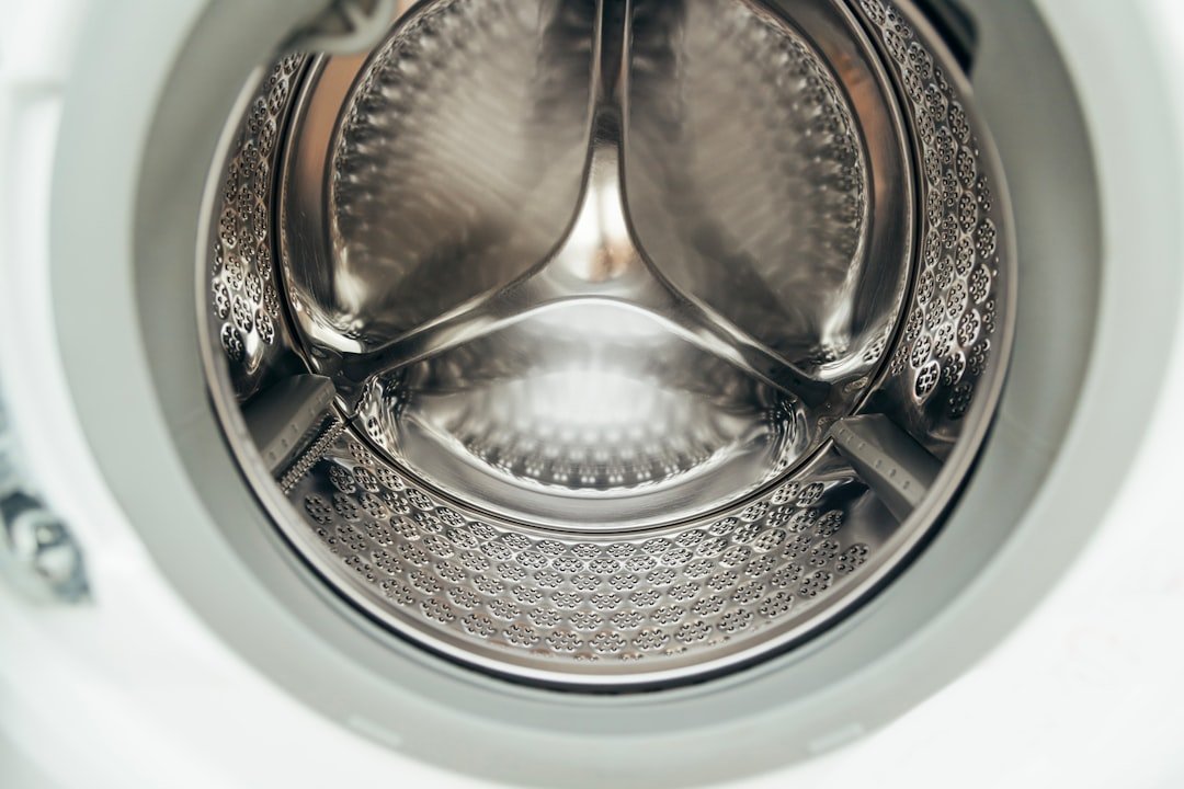 Inside view of a clean, empty washing machine drum.