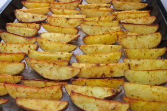 a pan filled with cooked potatoes on top of a table