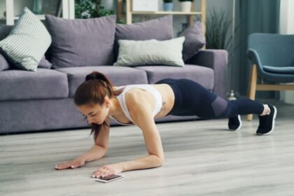 a woman is doing push ups on the floor