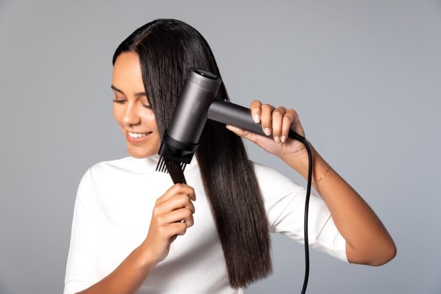 a woman blow drying her hair with a hair dryer