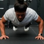 A man doing push ups in a gym