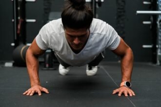 A man doing push ups in a gym