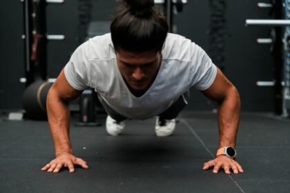 A man doing push ups in a gym