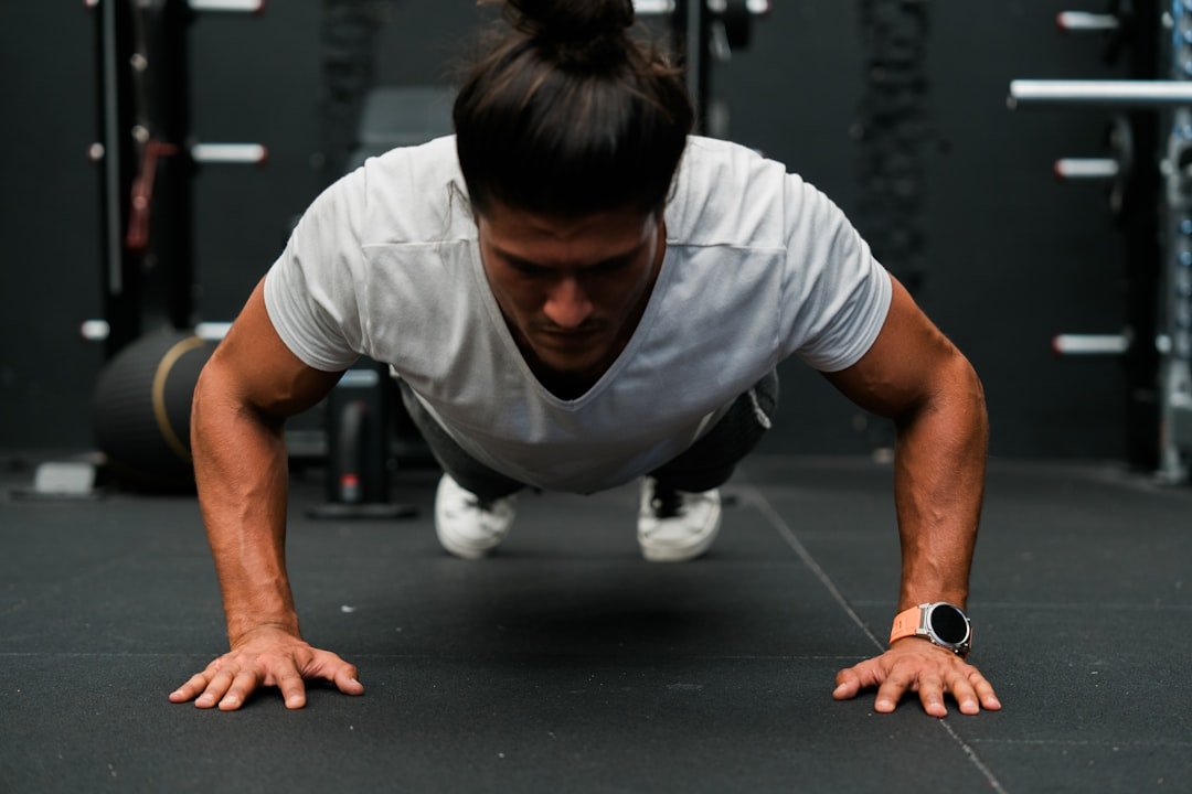A man doing push ups in a gym
