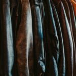 A row of leather jackets hanging on a rack