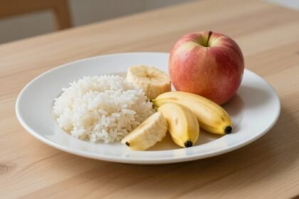 Πιάτο με ελαφριά και εύπεπτα φαγητά για στομαχόπονο, όπως λευκό ρύζι, μπανάνες και μήλα.