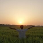 Μια γαλήνια σκηνή που απεικονίζει την ψυχική ευημερία, με έναν ζεστό ήλιο να ανατέλλει πάνω από ένα ήρεμο τοπίο.