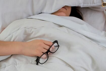 Tired exhausted woman sitting on bed morning light