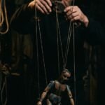Puppet strings controller abstract conceptual photo