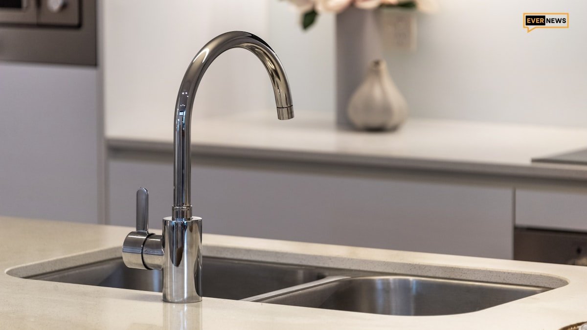 Clean sparkling stainless steel kitchen sink with modern faucet