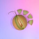 a cut in half kiwi fruit on a purple and pink background