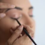person holding black pen in close up photography